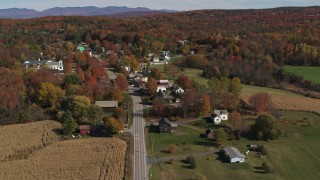 DX0002_217_009 - 5.7K stock footage aerial video of orbiting Main Street in a small town beside a forest in autumn, Orwell, Vermont