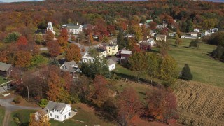 DX0002_217_014 - 5.7K aerial stock footage approach and orbit a small town in autumn, Orwell, Vermont