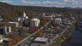 DX0002_218_015 - 5.7K aerial stock footage fly away from government office and state capitol building, reveal river, Montpelier, Vermont