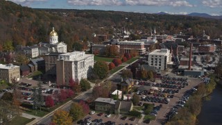 DX0002_218_017 - 5.7K aerial stock footage reverse view of government office and state capitol building near the river, Montpelier, Vermont