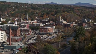 DX0002_218_028 - 5.7K aerial stock footage of flying by office buildings by the river, Montpelier, Vermont