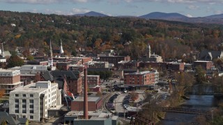 DX0002_218_029 - 5.7K aerial stock footage of passing by office buildings by the river, Montpelier, Vermont