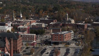 DX0002_218_045 - 5.7K aerial stock footage of passing office buildings beside the river, Montpelier, Vermont
