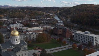 DX0002_219_012 - 5.7K aerial stock footage of government and brick office buildings near the river in Montpelier, Vermont