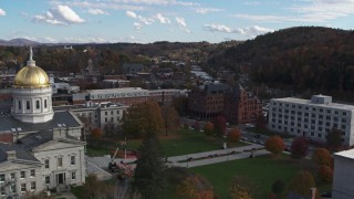 DX0002_219_016 - 5.7K aerial stock footage a view of government and brick buildings near the river while descending by the capitol, Montpelier, Vermont