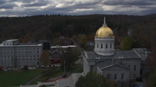 DX0002_219_023 - 5.7K aerial stock footage reverse view of the golden dome and front steps of the capitol building, Montpelier, Vermont