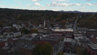DX0002_219_034 - 5.7K aerial stock footage orbit and fly away from church steeple and downtown buildings, Montpelier, Vermont