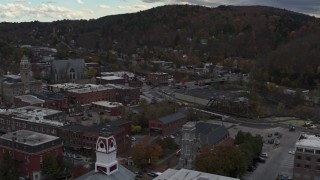 DX0002_219_048 - 5.7K aerial stock footage of flying by city hall and buildings by the river in downtown, Montpelier, Vermont