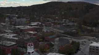 DX0002_219_049 - 5.7K aerial stock footage of flying by buildings by the river and city hall in downtown, Montpelier, Vermont