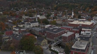 DX0002_219_062 - 5.7K aerial stock footage of orbiting and flying away from brick buildings and churches in downtown, Montpelier, Vermont