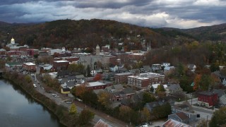 DX0002_220_007 - 5.7K aerial stock footage of approaching city hall from the river at sunset, Montpelier, Vermont