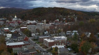 DX0002_220_009 - 5.7K aerial stock footage of a reverse view and orbit of city hall and brick buildings at sunset, Montpelier, Vermont