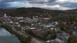 DX0002_220_010 - 5.7K aerial stock footage of a wide orbit of city hall and brick buildings at sunset, Montpelier, Vermont