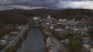 DX0002_220_016 - 5.7K aerial stock footage of flying by the river with a view of the state capitol at sunset, Montpelier, Vermont