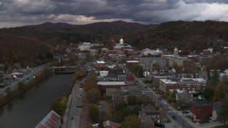 DX0002_220_021 - 5.7K aerial stock footage focus on the state capitol at sunset while flying by the river, Montpelier, Vermont