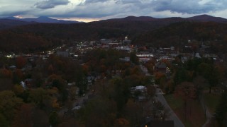 DX0002_220_053 - 5.7K aerial stock footage of a view of the downtown area of the city seen from homes and fall trees at twilight, Montpelier, Vermont