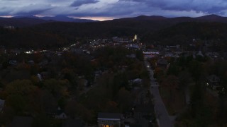DX0002_220_056 - 5.7K aerial stock footage of the downtown area of the city seen while flying by State Street at twilight, Montpelier, Vermont