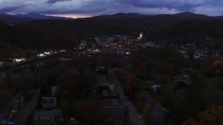 DX0002_220_057 - 5.7K aerial stock footage of the downtown area of the city seen from homes and State Street at twilight, Montpelier, Vermont