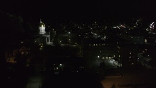 DX0002_221_017 - 5.7K aerial stock footage of the Vermont State Capitol behind a dark building at night, Montpelier, Vermont