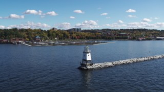DX0002_222_011 - 5.7K aerial stock footage orbit a lighthouse on Lake Champlain and reveal a marina, Burlington, Vermont