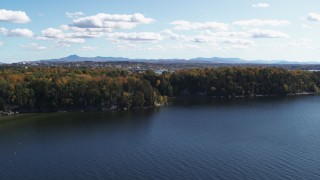 DX0002_223_006 - 5.7K aerial stock footage of a reverse view of forest on the shore of Lake Champlain, Burlington, Vermont