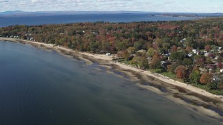 DX0002_223_020 - 5.7K aerial stock footage of a view of beachfront homes on the shore of Lake Champlain, Burlington, Vermont