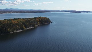 DX0002_223_021 - 5.7K stock footage aerial video of approaching forest on Lone Rock Point by Lake Champlain, Burlington, Vermont