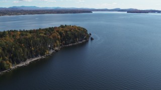 DX0002_223_022 - 5.7K aerial stock footage of approaching forest on the tip of Lone Rock Point by Lake Champlain, Burlington, Vermont