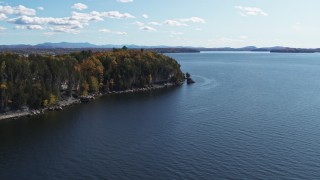 DX0002_223_024 - 5.7K aerial stock footage ascend away from forest on the tip of Lone Rock Point by Lake Champlain, Burlington, Vermont