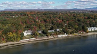 DX0002_223_027 - 5.7K aerial stock footage of orbiting four beachfront homes on the shore of Lake Champlain, Burlington, Vermont