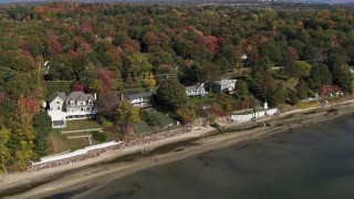 DX0002_223_030 - 5.7K aerial stock footage of orbiting four beachfront homes by the shore of Lake Champlain, Burlington, Vermont