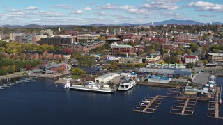 DX0002_224_002 - 5.7K aerial stock footage of orbiting city buildings and Ferry Dock Marina in downtown, Burlington, Vermont