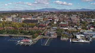 DX0002_224_003 - 5.7K aerial stock footage of orbiting city buildings and Burlington Community Boathouse Marina in downtown, Burlington, Vermont