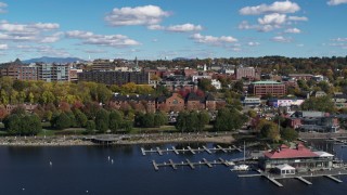DX0002_224_009 - 5.7K aerial stock footage of downtown buildings behind Waterfront Park and a marina, Burlington, Vermont