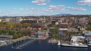 DX0002_224_010 - 5.7K aerial stock footage of downtown buildings seen while passing a marina, Burlington, Vermont