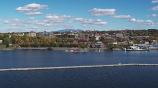 DX0002_224_014 - 5.7K aerial stock footage a view of downtown buildings seen while descending by breakwaters, Burlington, Vermont