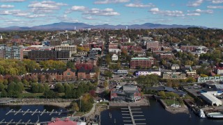 DX0002_224_018 - 5.7K aerial stock footage ascend from marina for view of city buildings and College Street, Burlington, Vermont