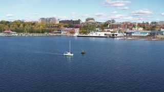 DX0002_224_024 - 5.7K stock footage aerial video of orbiting a sailboat on Lake Champlain, reveal downtown, Burlington, Vermont