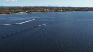 DX0002_224_026 - 5.7K aerial stock footage of tracking a speedboat racing past a breakwater on Lake Champlain near Burlington, Vermont