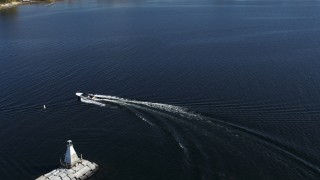 DX0002_224_027 - 5.7K aerial stock footage of tracking a speedboat racing around a lighthouse on Lake Champlain near Burlington, Vermont