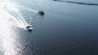 DX0002_224_030 - 5.7K aerial stock footage orbit a speedboat near another boat on Lake Champlain near Burlington, Vermont