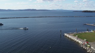 DX0002_224_031 - 5.7K aerial stock footage a speedboat approaching docks on Lake Champlain near Burlington, Vermont
