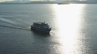 DX0002_224_043 - 5.7K stock footage aerial video tracking a ferry on Lake Champlain near the lighthouse in Burlington, Vermont