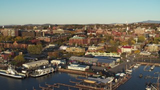 DX0002_224_072 - 5.7K aerial stock footage orbit downtown buildings behind Lake Champlain marina, Burlington, Vermont