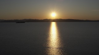 DX0002_225_002 - 5.7K aerial stock footage setting sun reflecting off the surface of Lake Champlain, Burlington, Vermont
