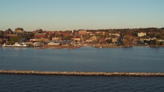 DX0002_225_003 - 5.7K aerial stock footage fly over breakwater toward a marina and downtown, Burlington, Vermont