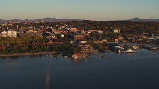 DX0002_225_007 - 5.7K aerial stock footage of flying away from park, buildings in downtown, and a marina, Burlington, Vermont