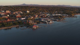 DX0002_225_009 - 5.7K stock footage aerial video ascend toward marinas and buildings in downtown at sunset, Burlington, Vermont