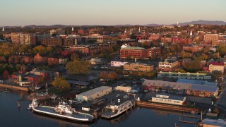 DX0002_225_011 - 5.7K stock footage aerial video orbit buildings in downtown and marina at sunset, Burlington, Vermont