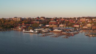 DX0002_225_012 - 5.7K stock footage aerial video fly away from and orbit buildings in downtown behind marinas at sunset, Burlington, Vermont